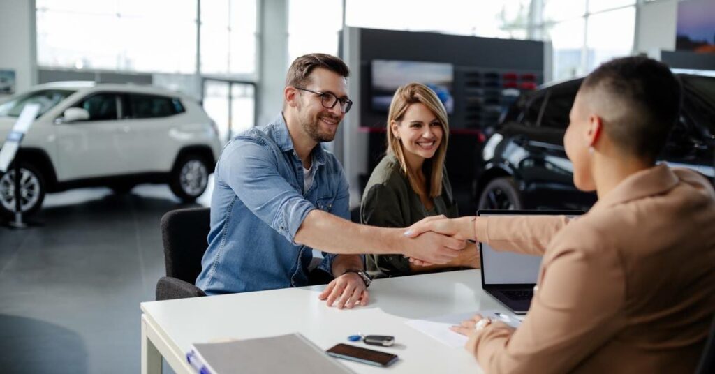 Car Dealer Shaking Hands with A Happy Customer